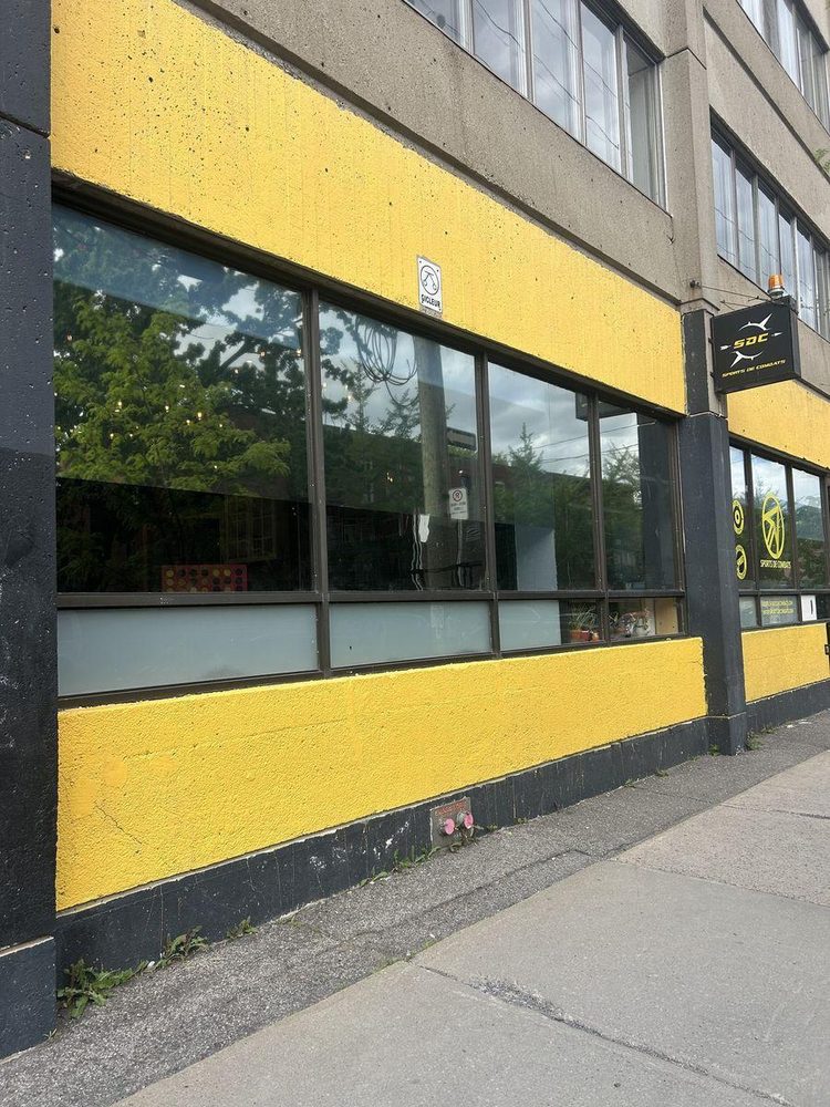 Yellow SDC storefront — garage entrance to the left