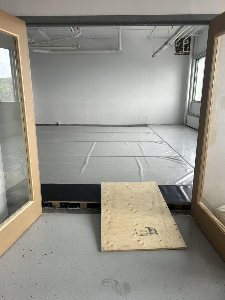Double-door studio — plywood ramp bridging the raised floor