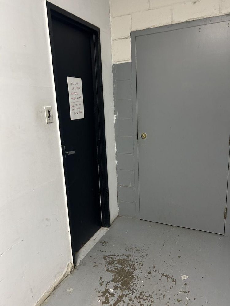 Bathroom entrance — narrow door, knob and key access